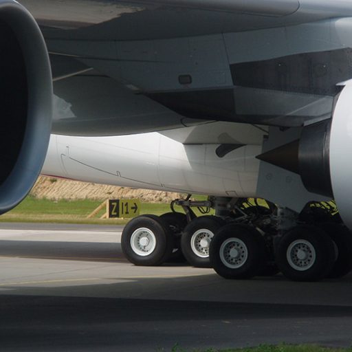 Close-up of two airplanes with focus on the landing legs.