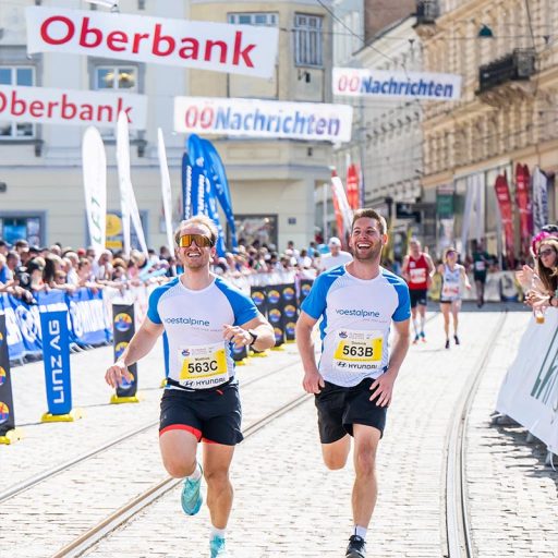 voestalpine employees run together on the home stretch of the linz marathon