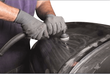 A man doing the functional polishing on a surface