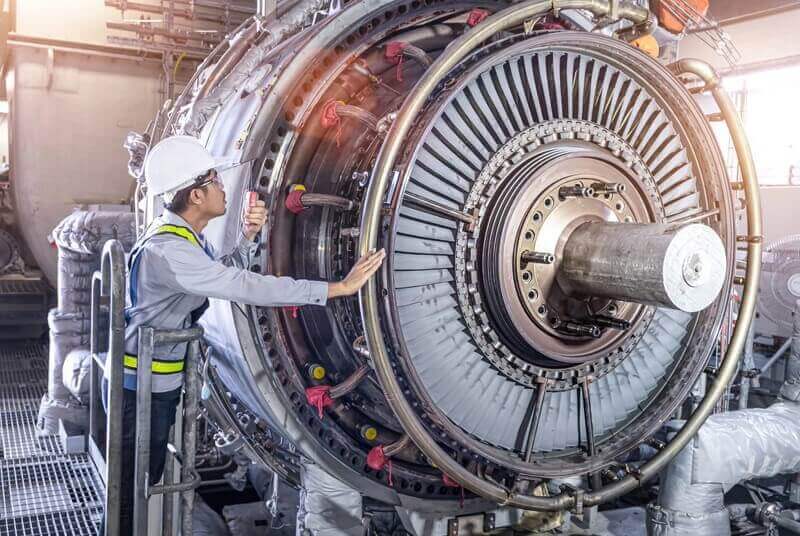 Man in safety gear working on a turbine